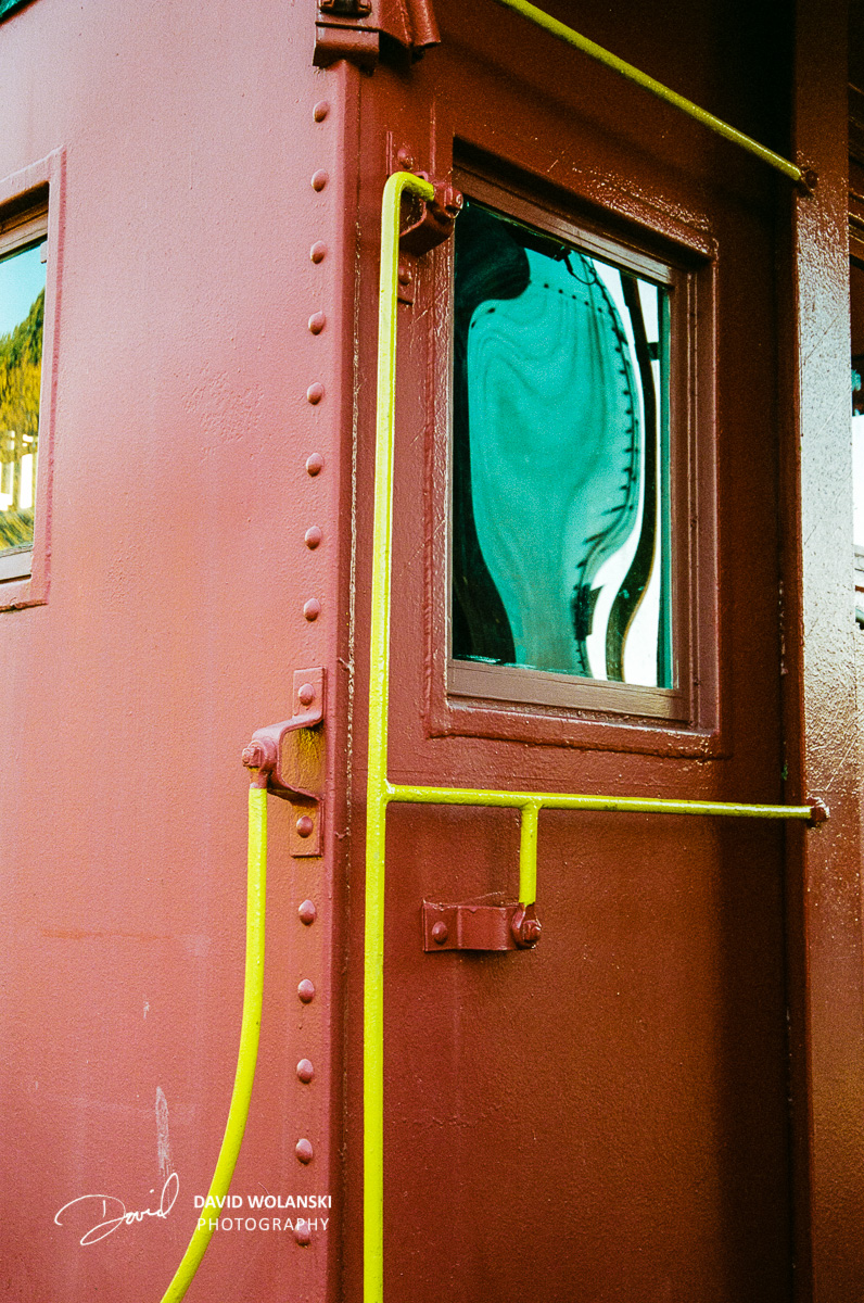 I was interested most in the yellow rails and the red of the car. Then I noticed the smear of green in the window. 