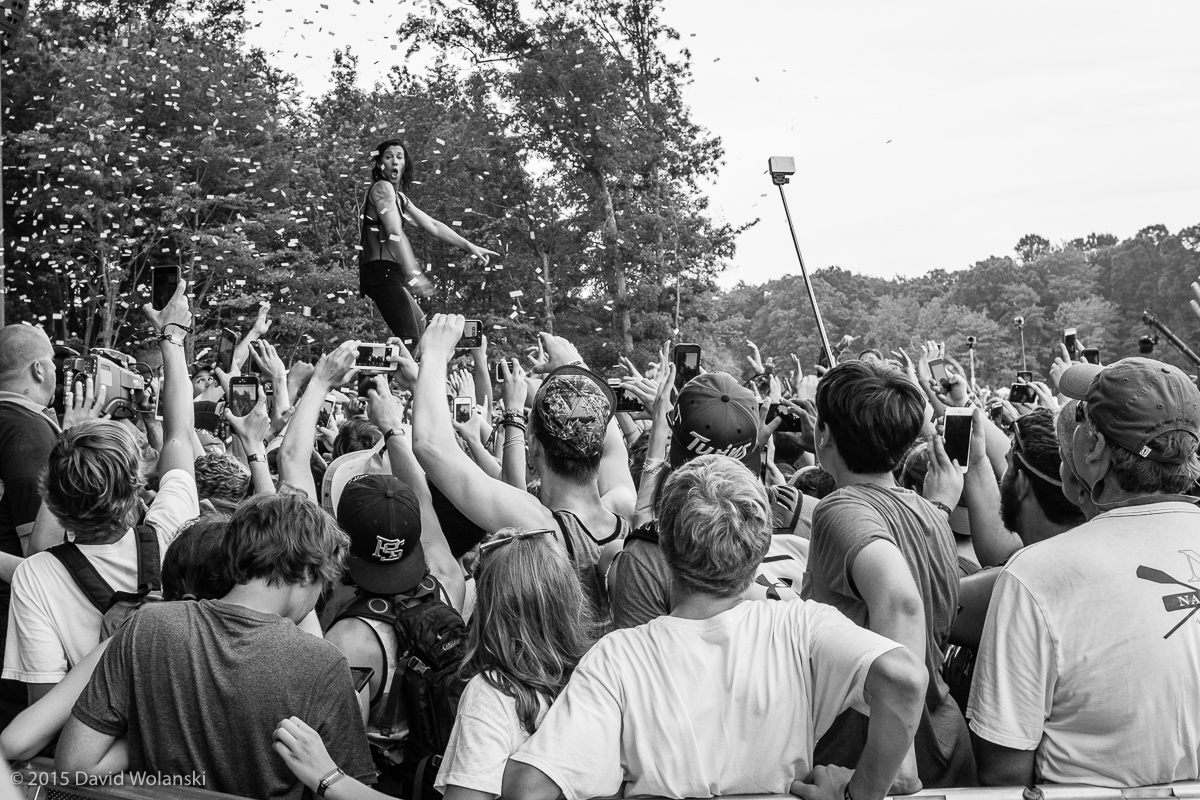 Kim of Matt and Kim standing on audience member hands at Firefly 2015